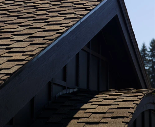 A close-up image of brown asphalt shingles installed by Bill West Roofing.