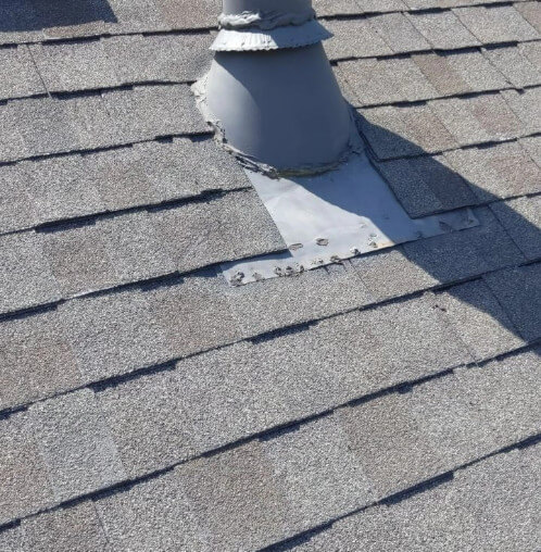 A Blue Springs, Missouri home with a shingle roof and a pipe boot being worked on.