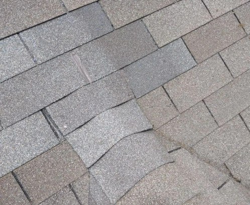 An overhead view of asphalt shingles on a roof in Blue Springs, Missouri.