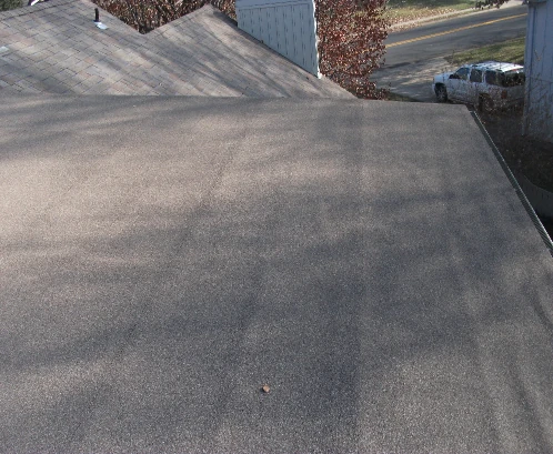 A home with a partial flat roof installed by Bill West Roofing.