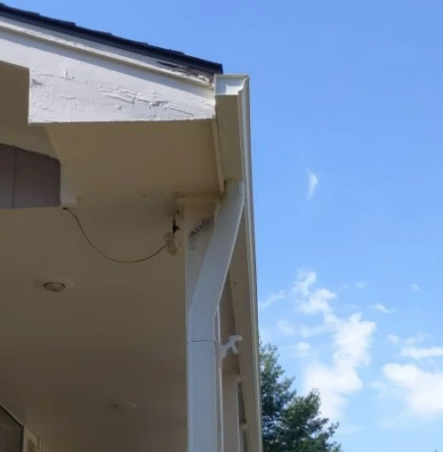 A new gutter system and downspout installed on a home in Kansas City by Bill West Roofing.