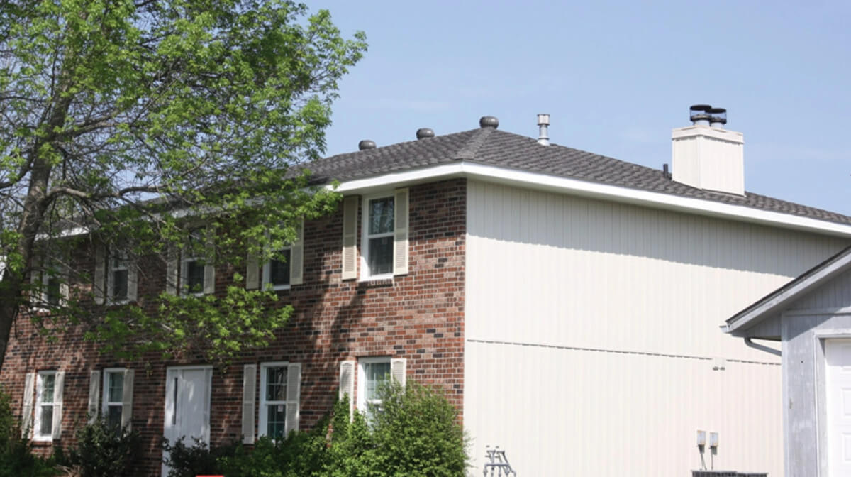 A multi family home with a new shingle roof installed by Bill West Roofing.