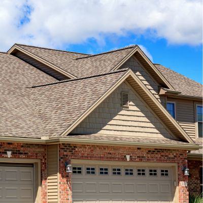 brick house in Kansas City with a new energy efficient roof installed by Bill West Roofing